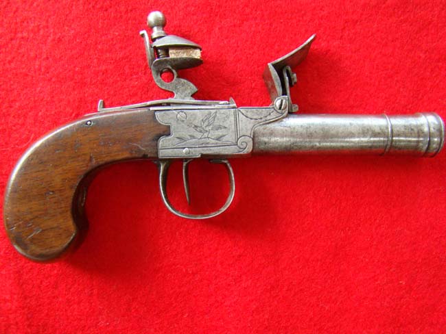 A British flintlock .50 cal. pocket pistol with cannon barrel and walnut grips circa 1790